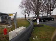 Large concrete blocks kept the bypass lines clear of the airport property. Trunk padding was also used to protect adjacent trees.